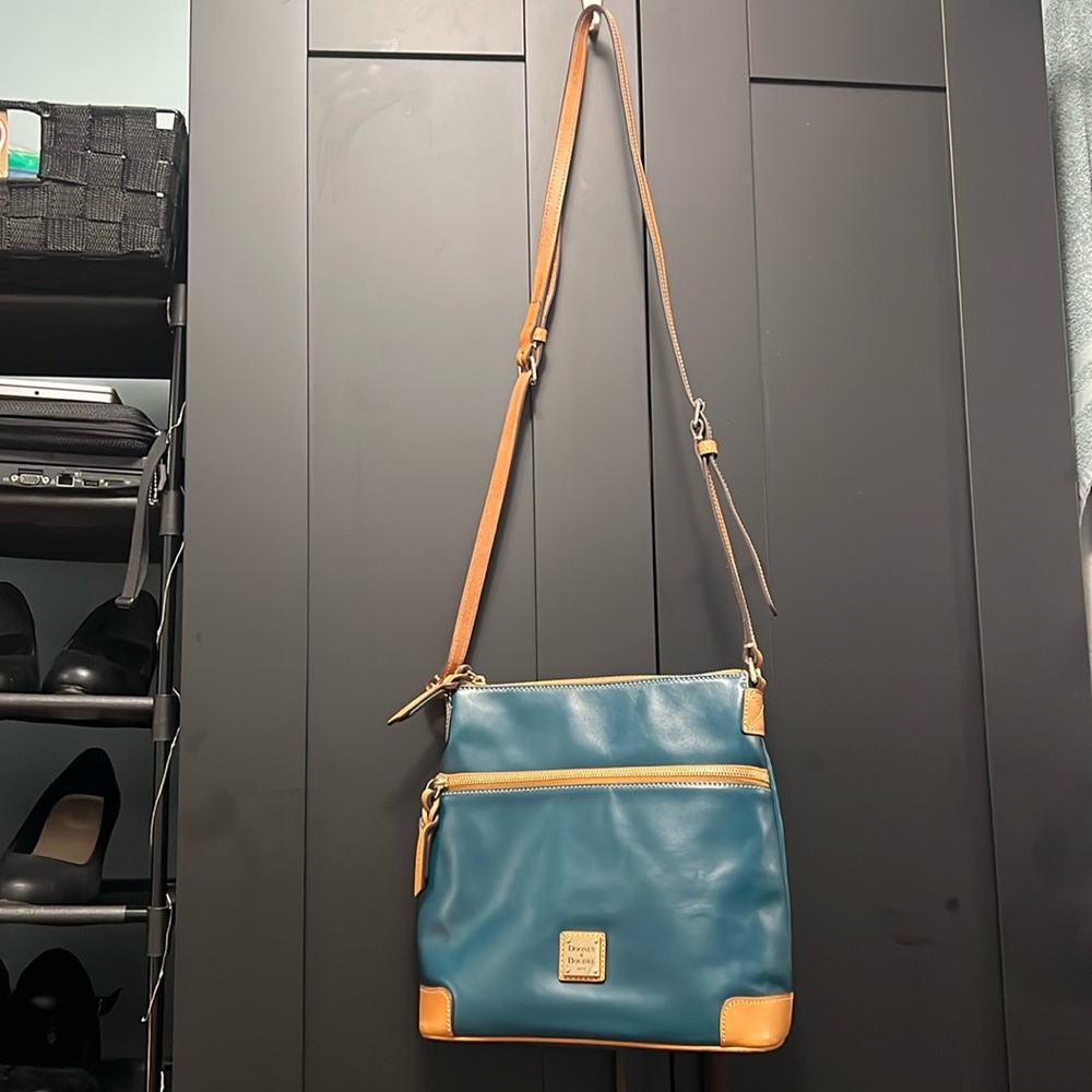 Dooney and Bourke Genuine Leather Crossbody bag. Teal/Camel trim.